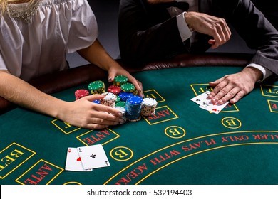 couple playing poker at the table